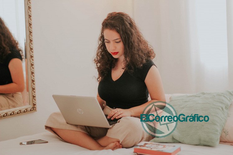 woman in black tank top using macbook