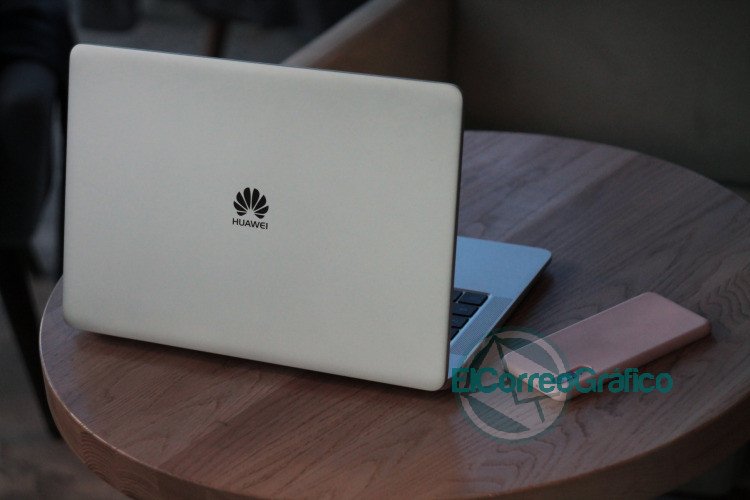 silver macbook on brown wooden table