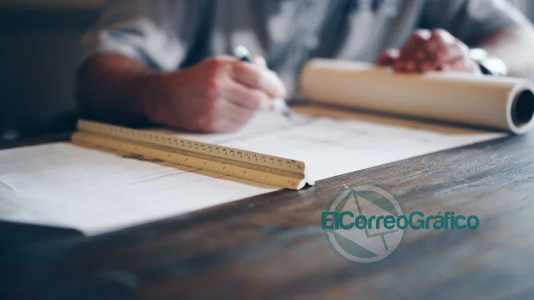 person drafting on blueprint