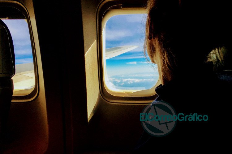 person looking outside of airplane window